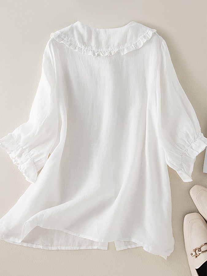 Blusa donna bianca con vestibilità ampia, colletto arricciato e maniche lunghe, perfetta per un look elegante e confortevole.