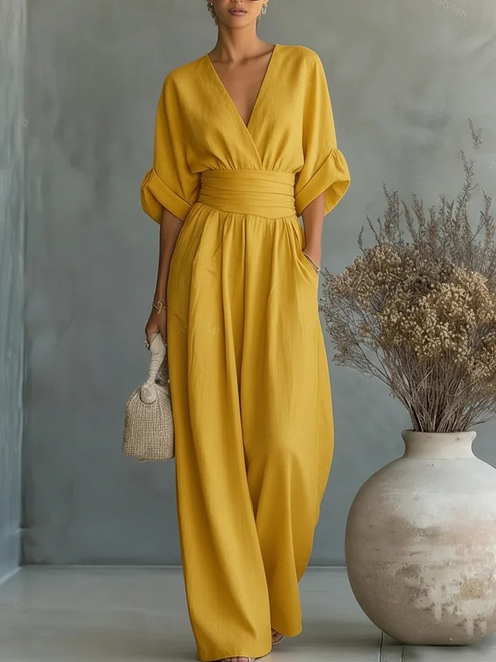 Tuta da donna elegante con scollo a V e pantaloni a gamba larga, disponibile in vari colori.