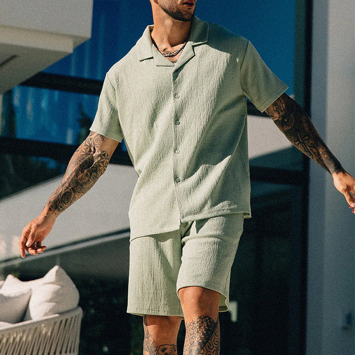 Moda uomo streetwear: completo estivo casual con t-shirt a stampa e pantaloncini. Set due pezzi alla moda.