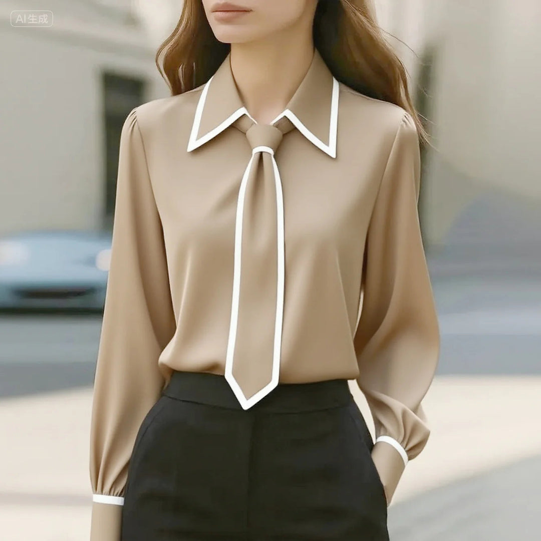Blusa donna elegante versatile con colletto a contrasto, maniche lunghe. Ideale per look da ufficio o casual chic.