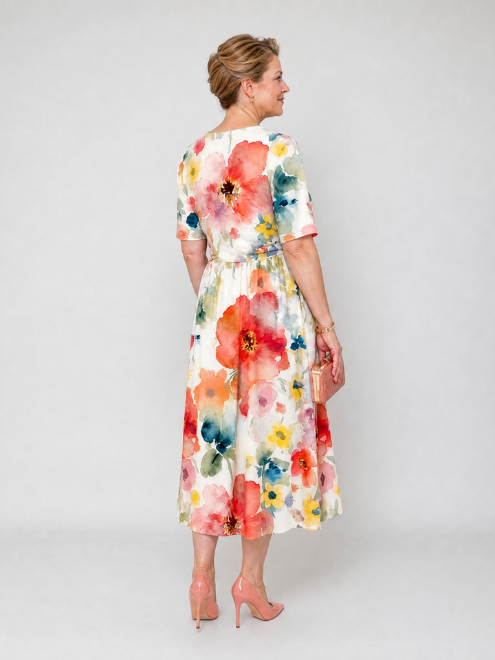 Comodo abito midi floreale da donna, leggero e fresco. Presenta scollo a V e maniche corte, ideale per l'estate.