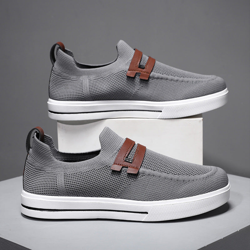 Sneakers slip-on da uomo grigie, leggere e comode, perfette per viaggi e look casual.