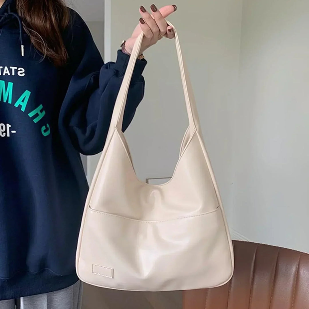 Borsa hobo color crema donna, stile minimal, perfetta per look casual e versatili ogni giorno.