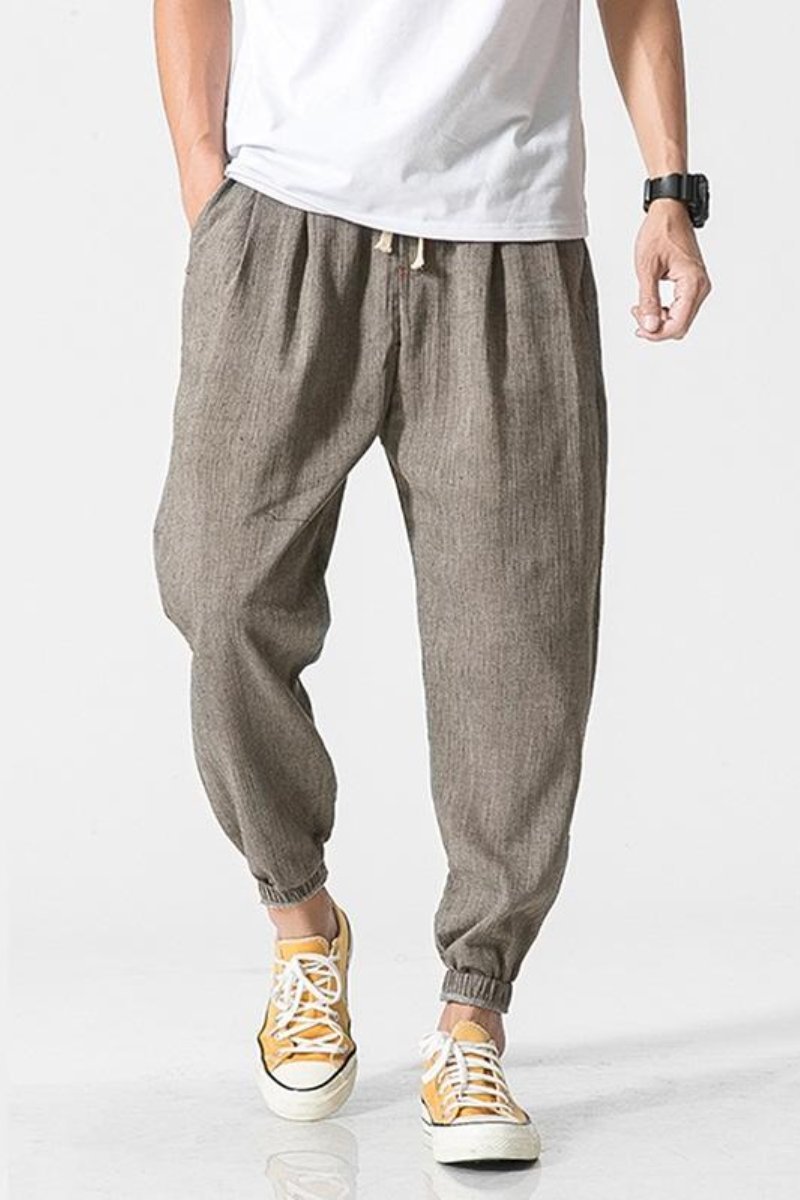 Pantaloni jogger uomo harem grigi, vita elastica, vestibilità ampia per comfort streetwear.