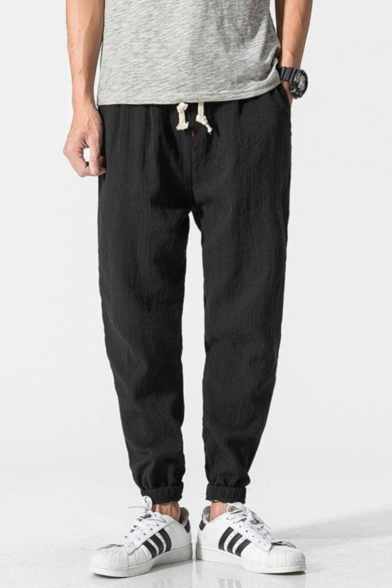 Jogger uomo casual in cotone, pantaloni harem larghi con vita elastica per streetwear estivo.