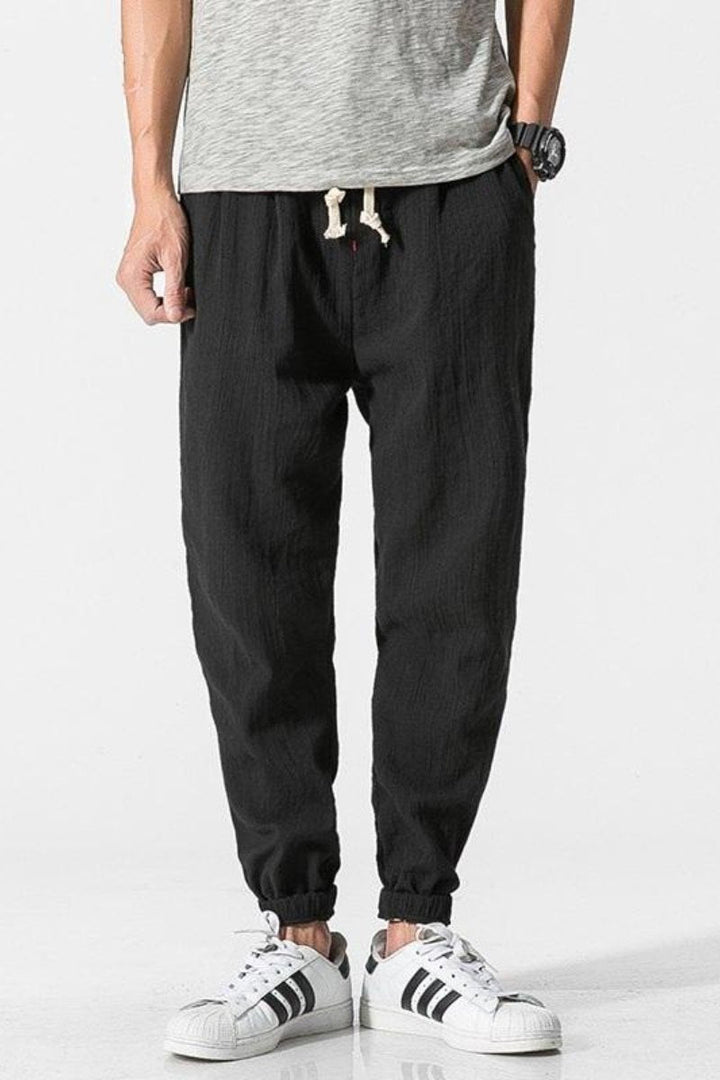 Jogger uomo casual in cotone, pantaloni harem larghi con vita elastica per streetwear estivo.
