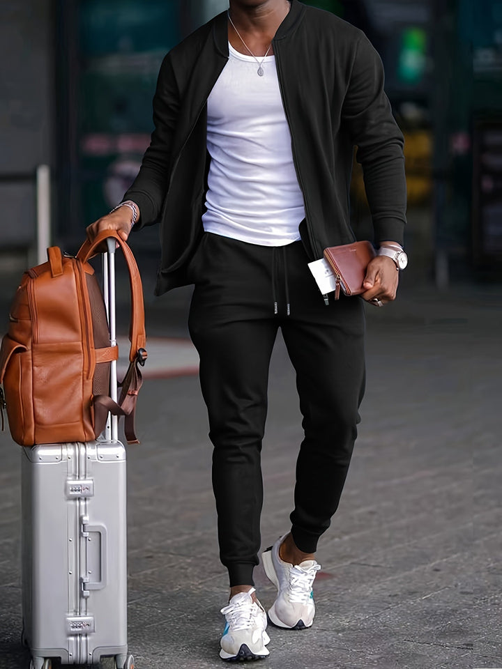 Tuta sportiva uomo elegante completa di giacca con cerniera e jogger regolabili, perfetta per fitness e look urbano.