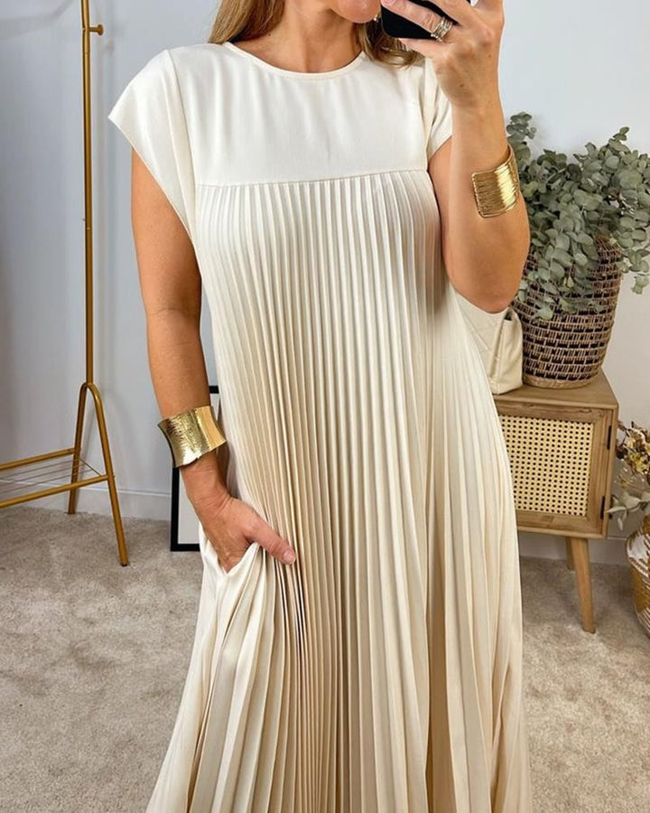 Abito da cerimonia donna, plissettato e maxi, con design fluido ed elegante.