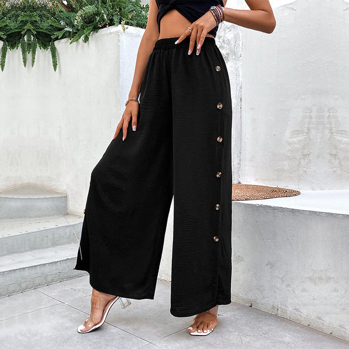 Pantaloni donna vita alta neri, dal taglio a gamba larga con spacchi laterali. Eleganza e design contemporaneo.