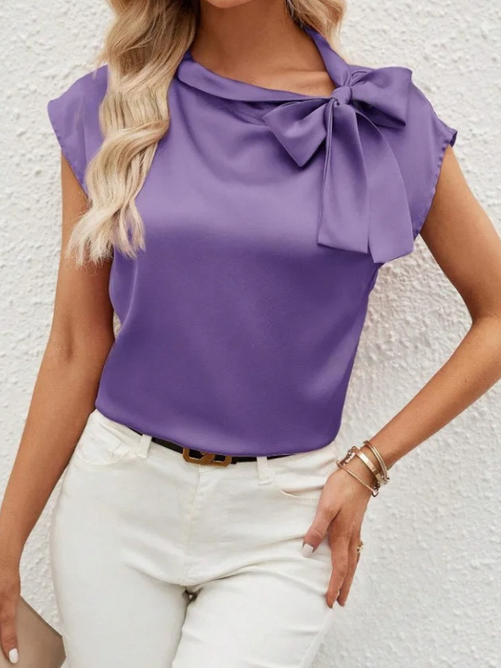Camicetta da donna con fiocco, design fluido e moderno, perfetta per un look casual o formale.