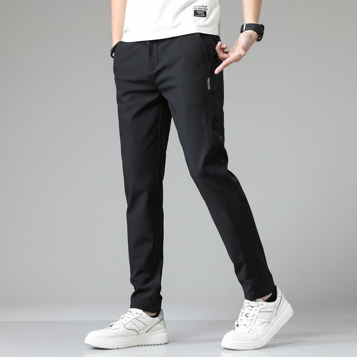 Vista frontale: pantaloni uomo affusolati neri, taglio moderno e antipiega, per un look business impeccabile.