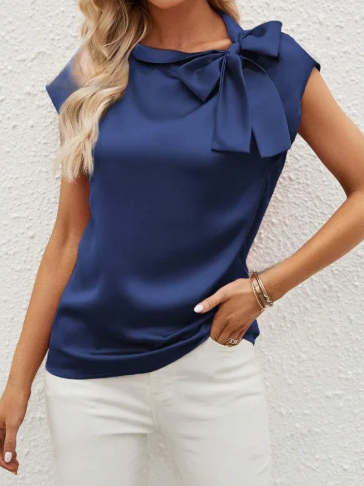 Camicetta da donna elegante con fiocco, ideale per ufficio o cena, stile versatile e chic.