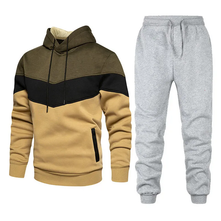 Completo tuta uomo due pezzi patchwork, con felpa con cappuccio e pantaloni sportivi. Perfetto per look casual o allenamento.