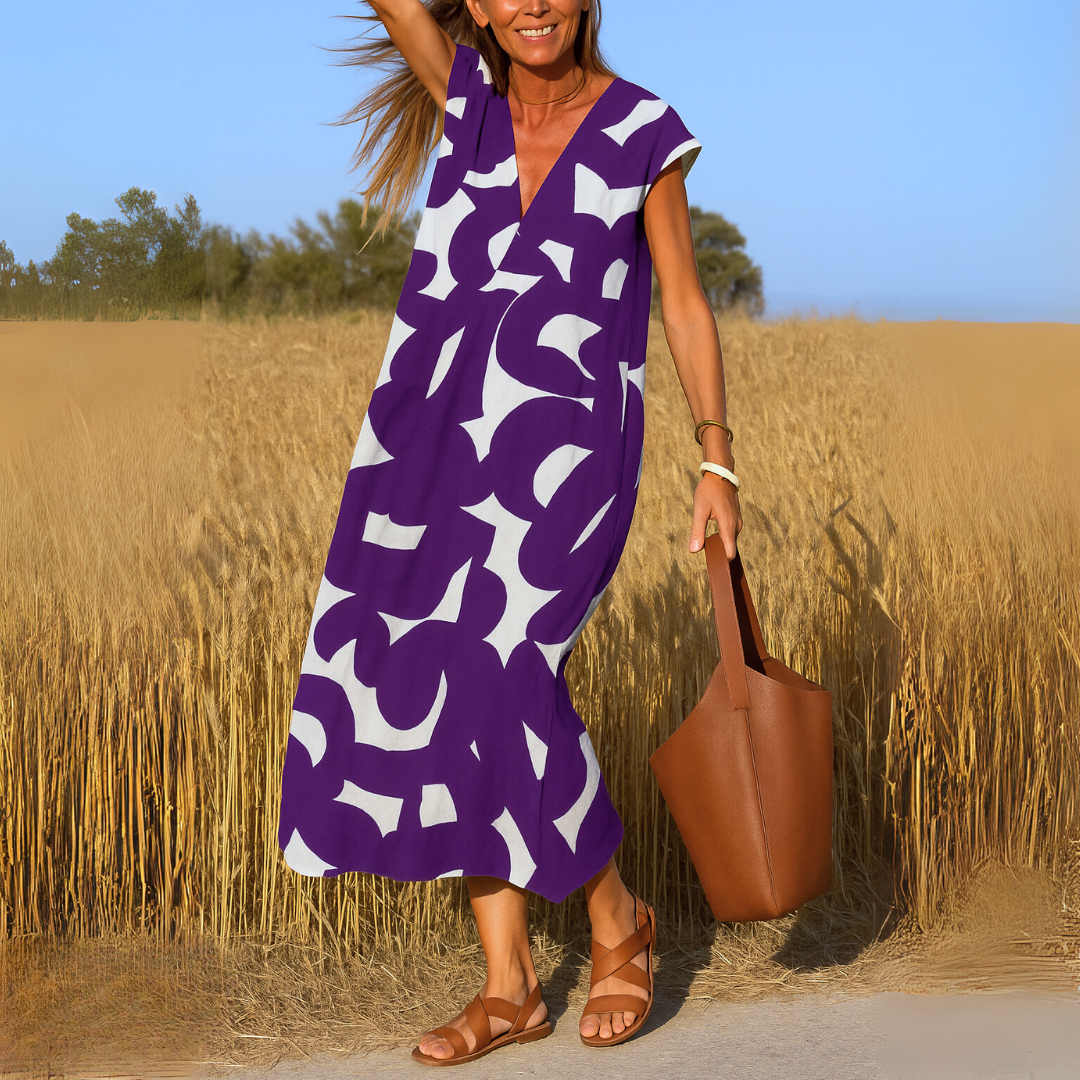Abito midi donna con scollo a V e stampa geometrica, un look versatile per il giorno e la sera.