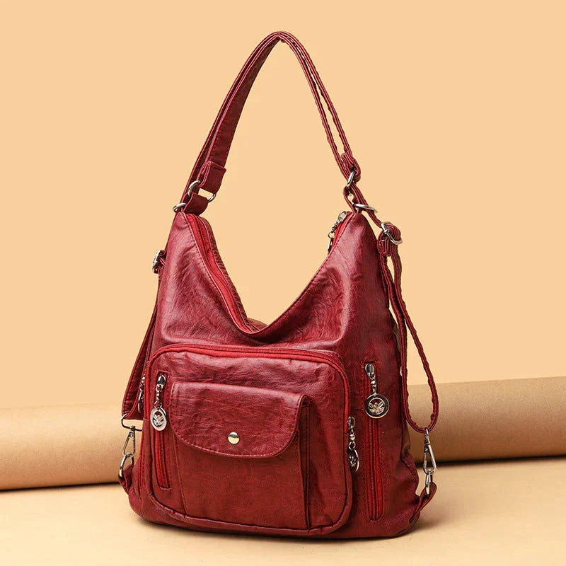 Borsa da viaggio multitasche in pelle, comoda tracolla regolabile. Perfetta per la donna organizzata.