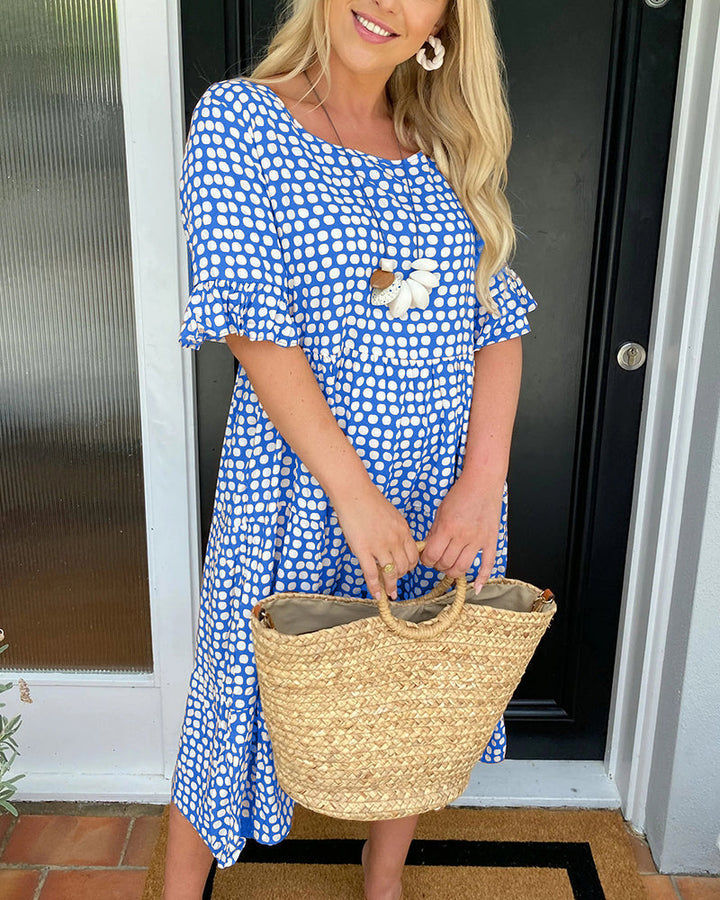 Abito a pois midi per donna, stile estivo e casual, con scollo rotondo e taglio fluido.
