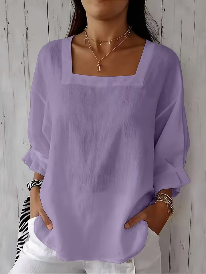Elegante blusa donna con scollo quadrato e maniche fluide. Perfetta per occasioni speciali o look casual primaverili.