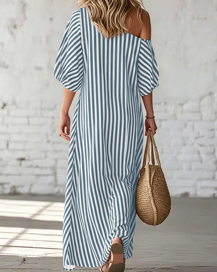 Moda donna estiva: abito lungo a righe, spallina singola e volant. Chic e confortevole per ogni occasione.