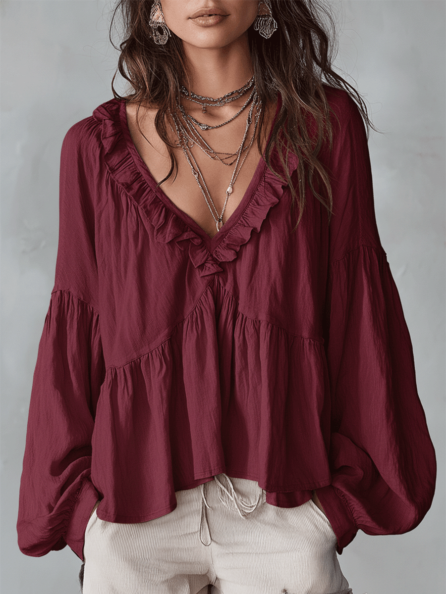 Blusa donna con volant e maniche lunghe, tessuto leggero per comfort e stile.