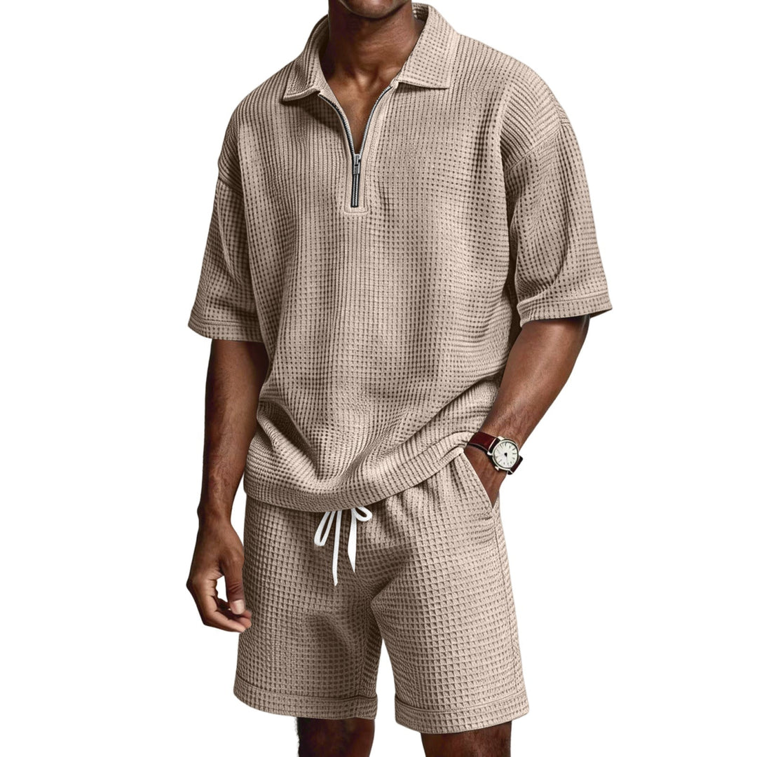 Moda uomo estiva: completo casual due pezzi con polo zip e pantaloncini, ideale per il tempo libero.