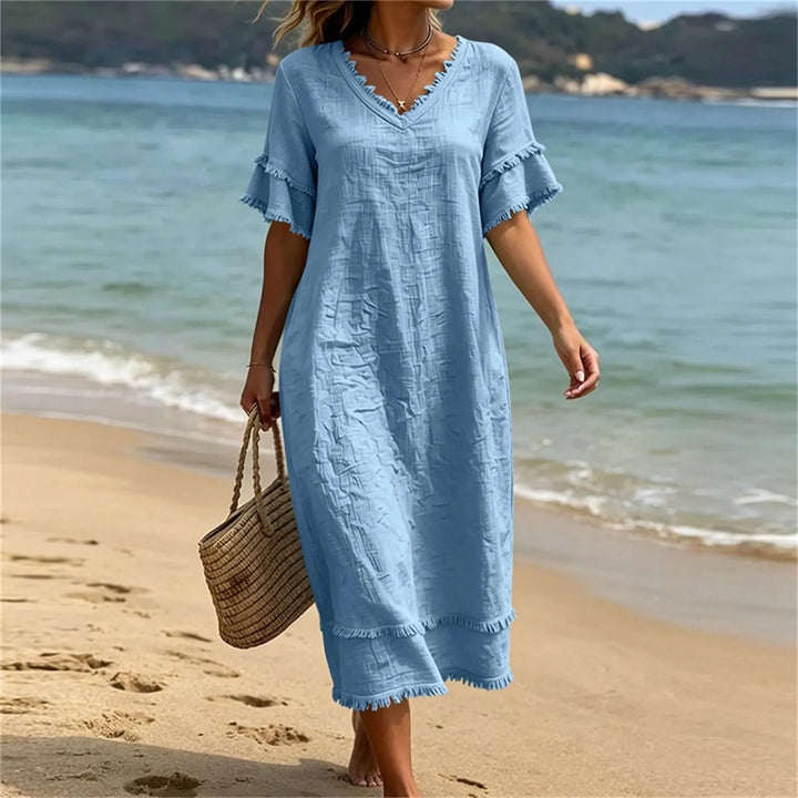 Abito bohémien in poliestere con scollo a V e frange, per un look casual estivo.