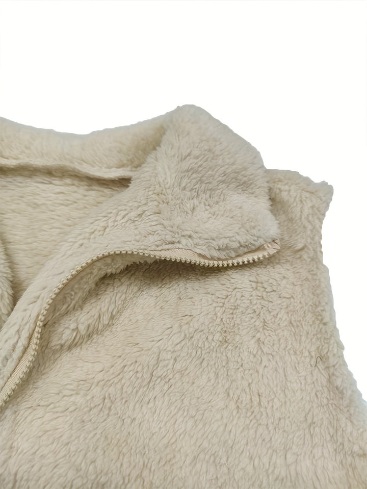 Gilet donna trendy in pelliccia teddy spento bianco, senza maniche, con zip. Perfetto per outfit casual-eleganti.