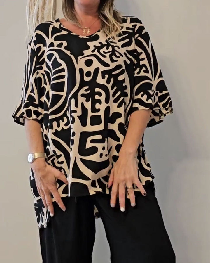 Top donna ampio e moderno con vivace stampa astratta, perfetto per primavera/estate. Comfort casual chic.