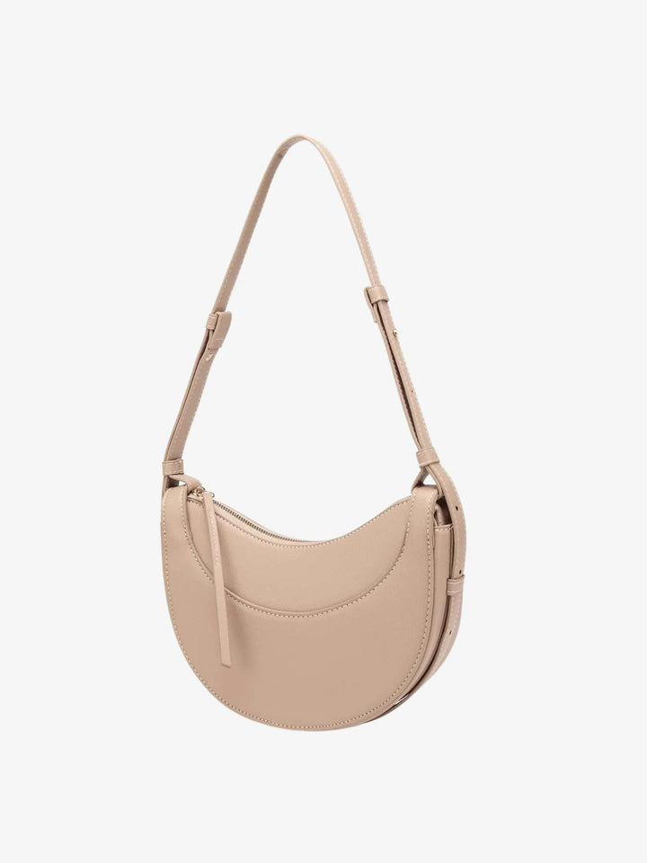 Borsa a tracolla curva donna con nappina, un must-have per la moda e la praticità quotidiana.
