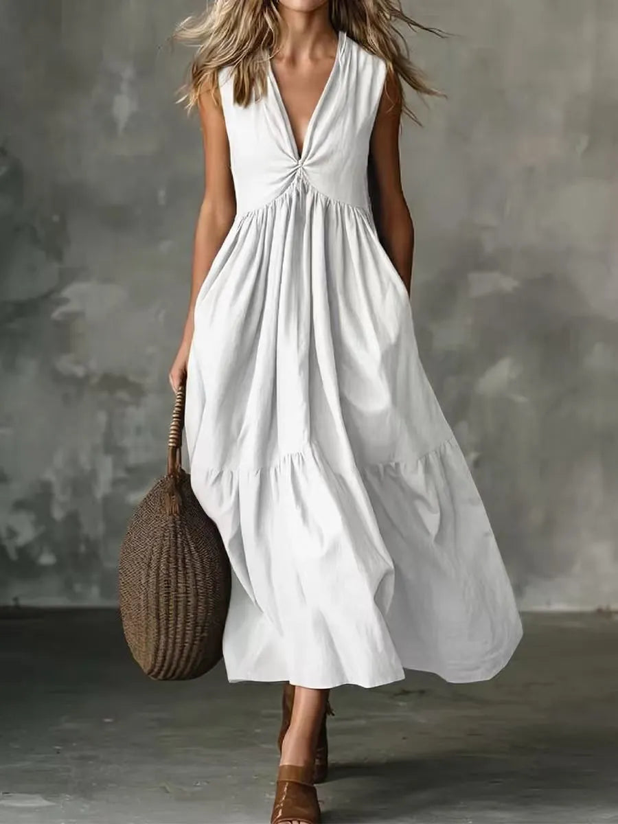 Abito midi donna estivo senza maniche, scollo a V, con tasche laterali. Perfetto per un look casual o elegante in misto cotone.