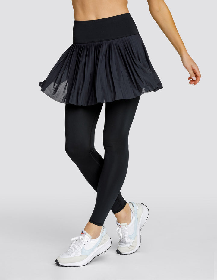 Leggings donna vita alta con gonna plissettata integrata e tasche laterali, ideali per sport e fitness.