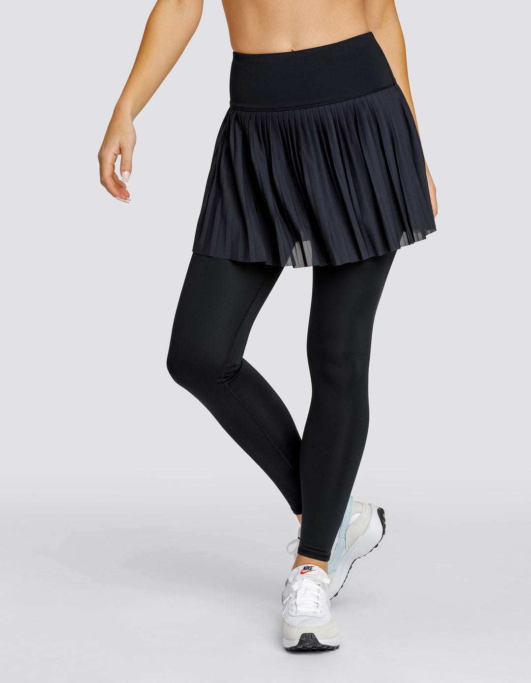 Leggings donna comodi vita alta, con gonna plissettata e pratiche tasche. Ottimi per abbigliamento sportivo e moda.