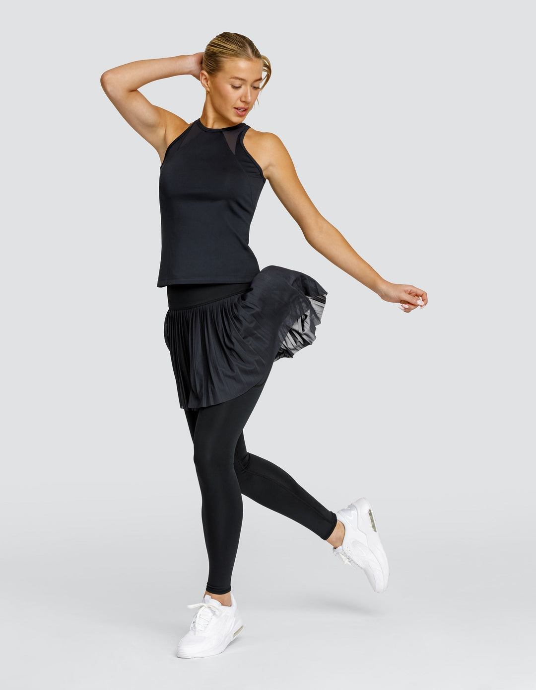 Leggings donna vita alta con gonna plissettata e tasche, versatili per sport, fitness, athleisure e outfit alla moda.