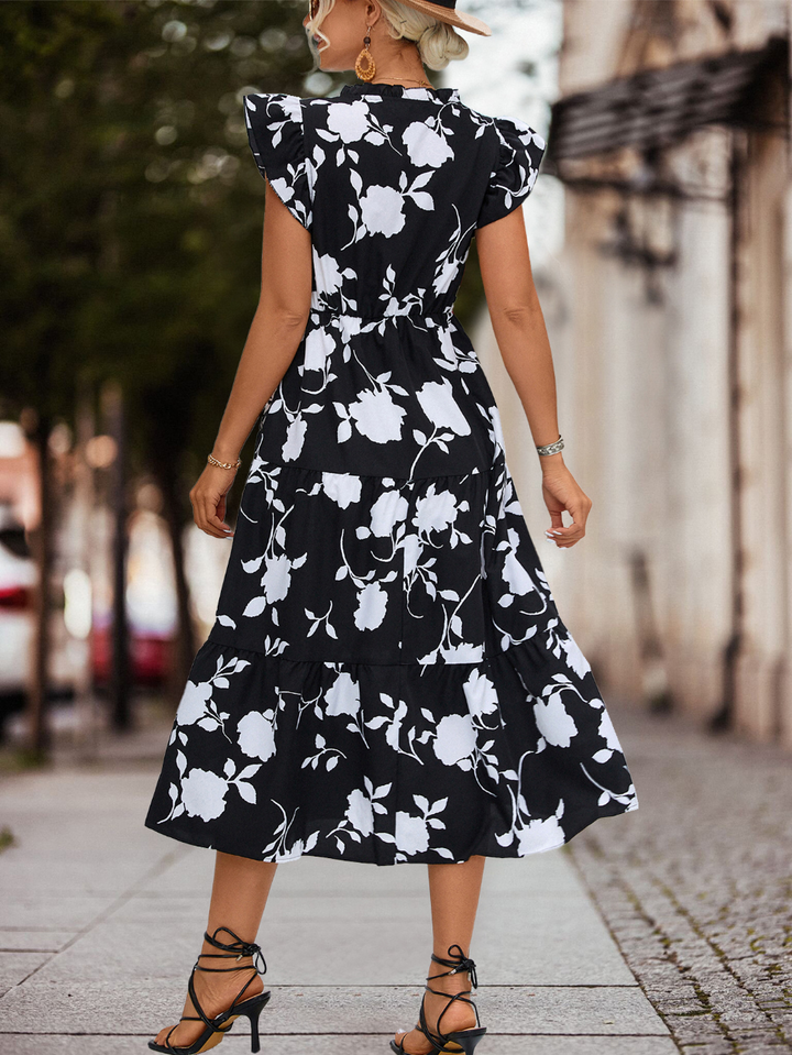 Vestito midi floreale da donna, stile boho-chic elegante e casual, con balze fluide per un look primaverile estivo.