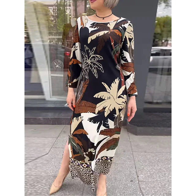 Vestito donna midi nero elegante con stampa tropicale, maniche lunghe. Silhouette dritta, ideale per look sofisticati estivi o casual.