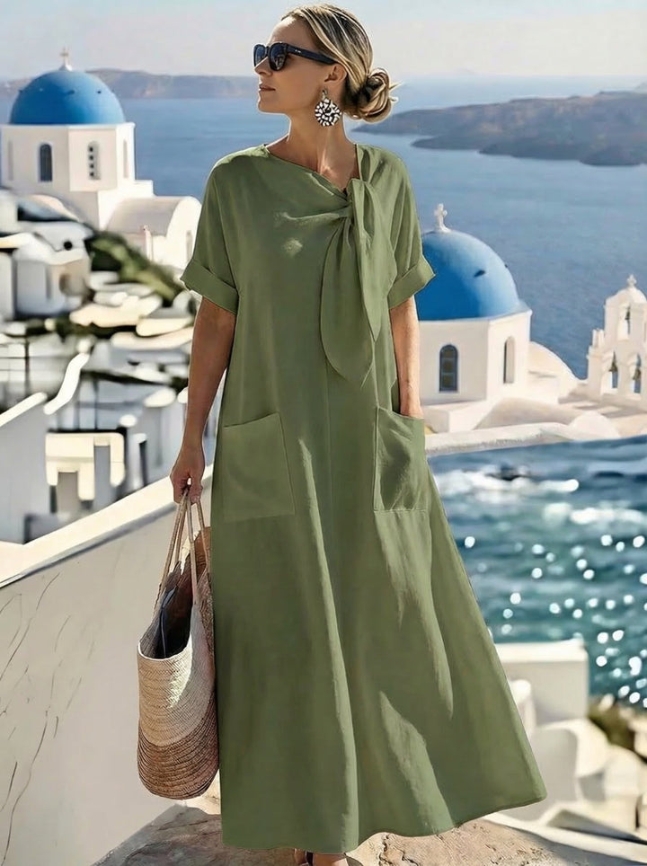 Abito maxi donna con nodo e tasche ampie, un capo essenziale per un outfit elegante e confortevole.