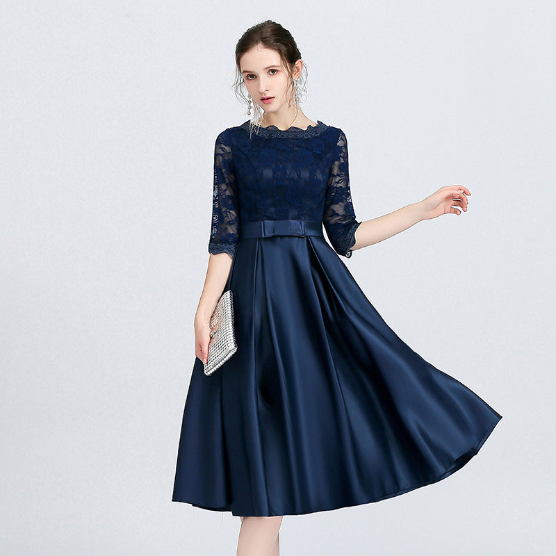 Abito donna midi blu scuro con fiocco e dettagli raffinati, ideale per matrimoni e cerimonie.