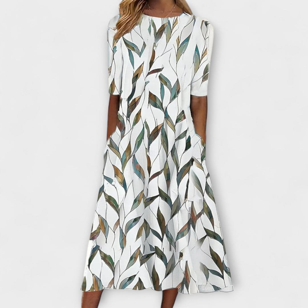 Elegante vestito midi donna con stampa floreale botanica blu scuro e verde. Ideale per primavera estate, look casual chic.