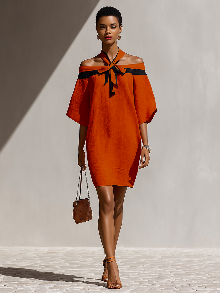 Chic abito donna arancione con spalle scoperte, fiocco frontale e maniche balloon, ideale per primavera/estate.