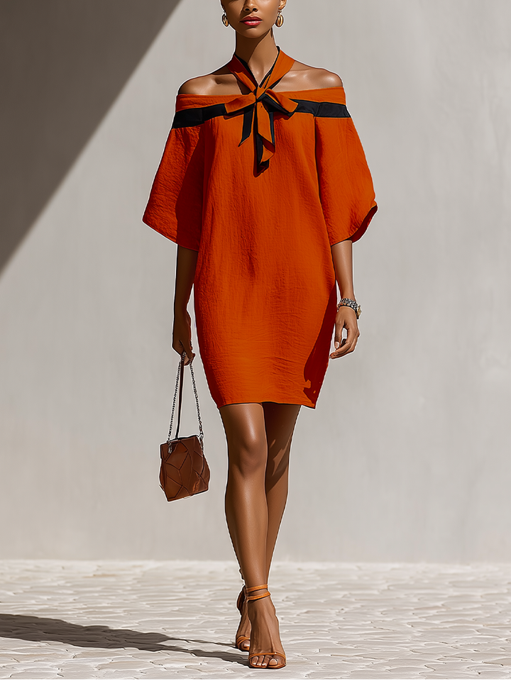 Terracotta mini abito off-shoulder con fiocco e maniche balloon, perfetto per outfit estivi eleganti e chic.