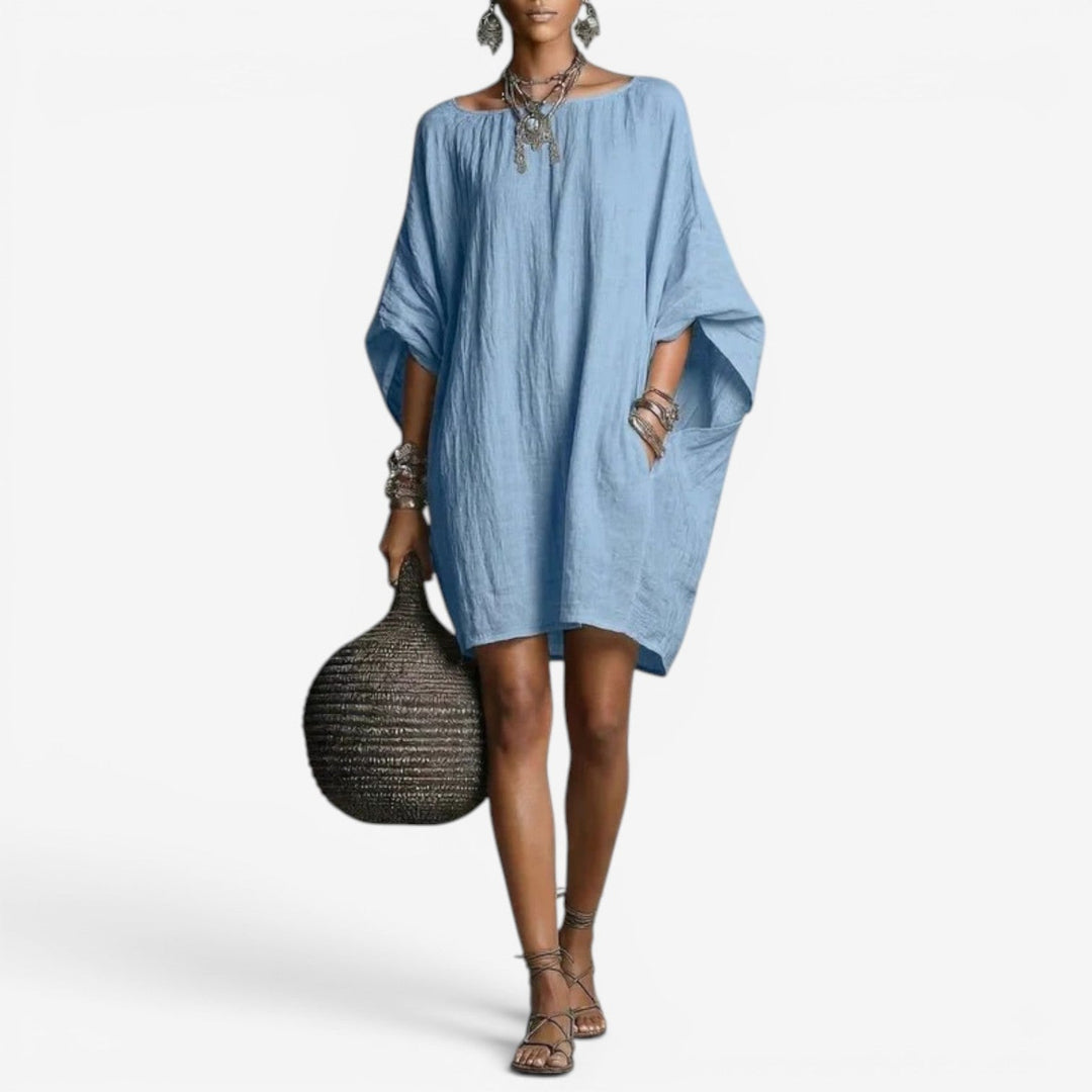 Abito estivo mini donna oversize con maniche a pipistrello e girocollo, stile fluido e casual.