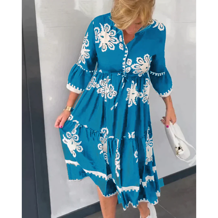 Abito elegante fluido da donna con fantasia floreale e cintura regolabile, perfetto per eventi estivi o look casual chic.