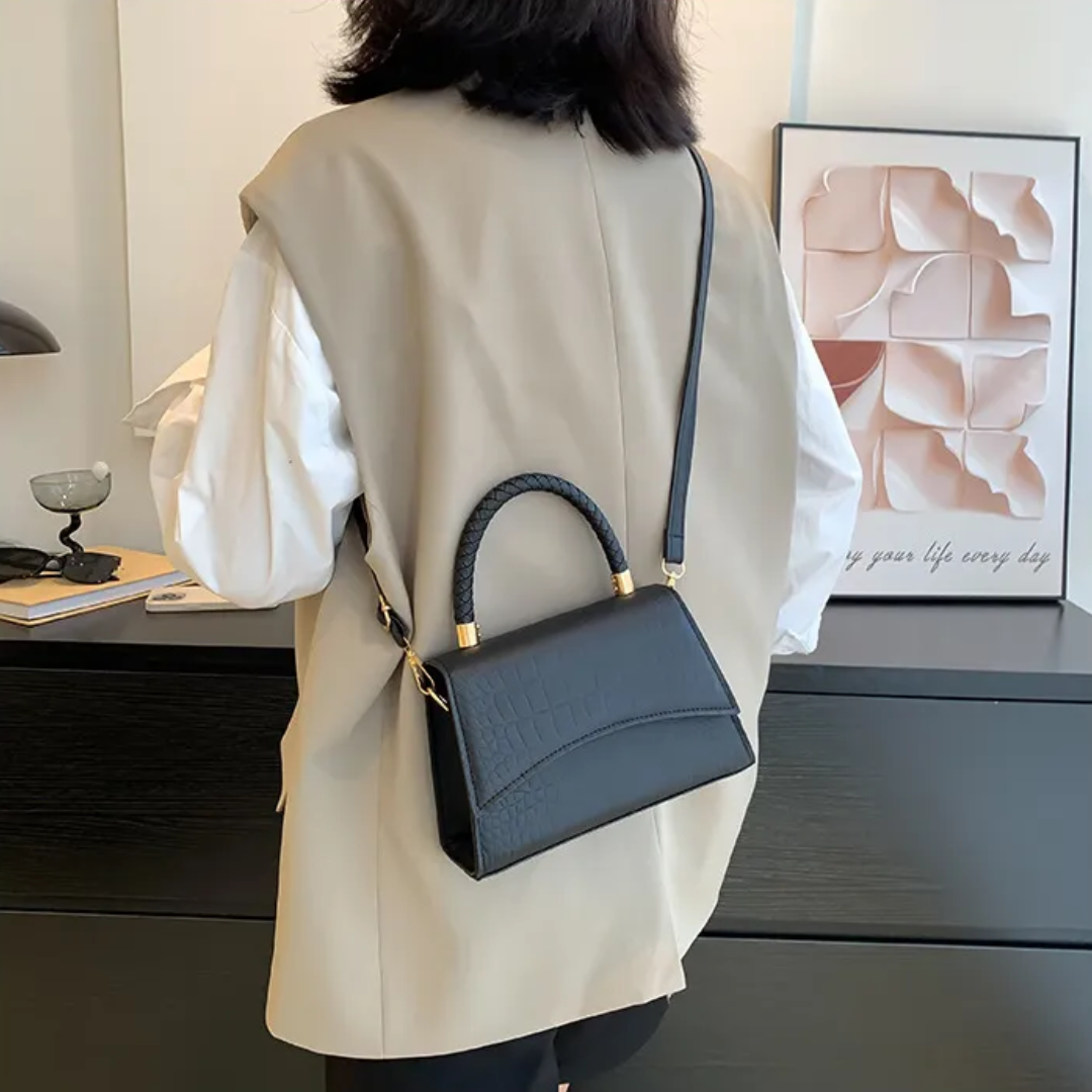 Borsa a mano donna nera in similpelle, design elegante. Accessorio moda versatile con tracolla regolabile.