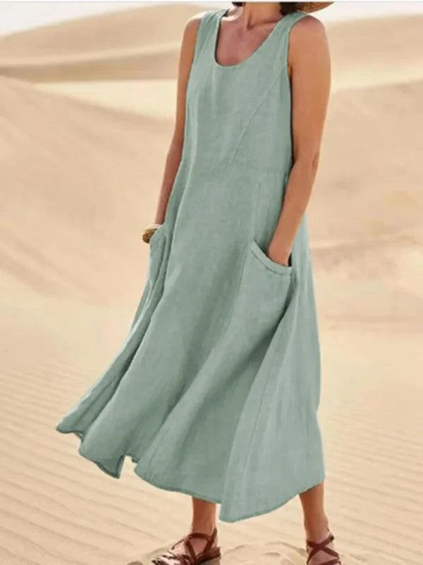 Abito midi estivo per donna, senza maniche, con tasche, confortevole e ampio, ideale per giornate calde.
