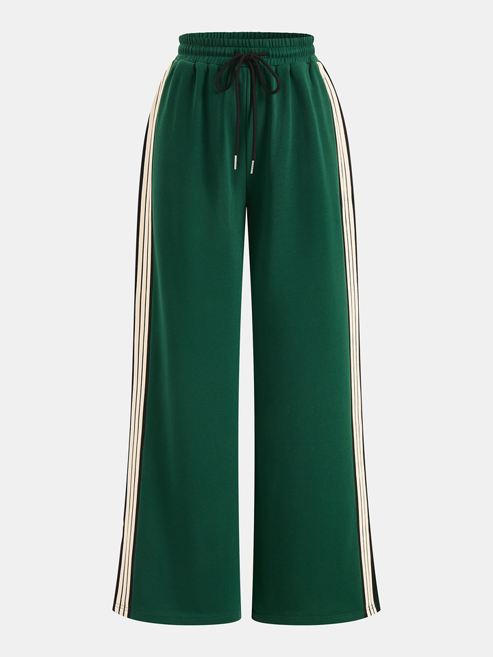 Pantaloni tuta donna a vita media, gamba larga e banda laterale. Comfort e stile per il tuo tempo libero.