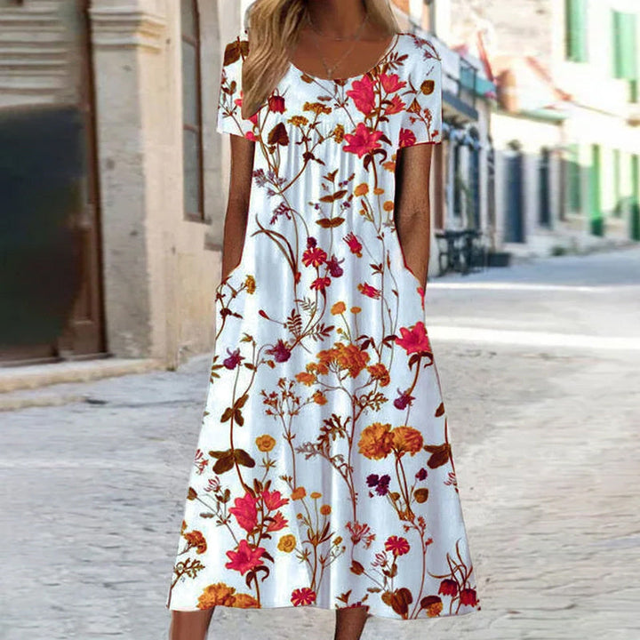 Abito lungo donna floreale svasato senza maniche. Design elegante e versatile, perfetto per l'estate.