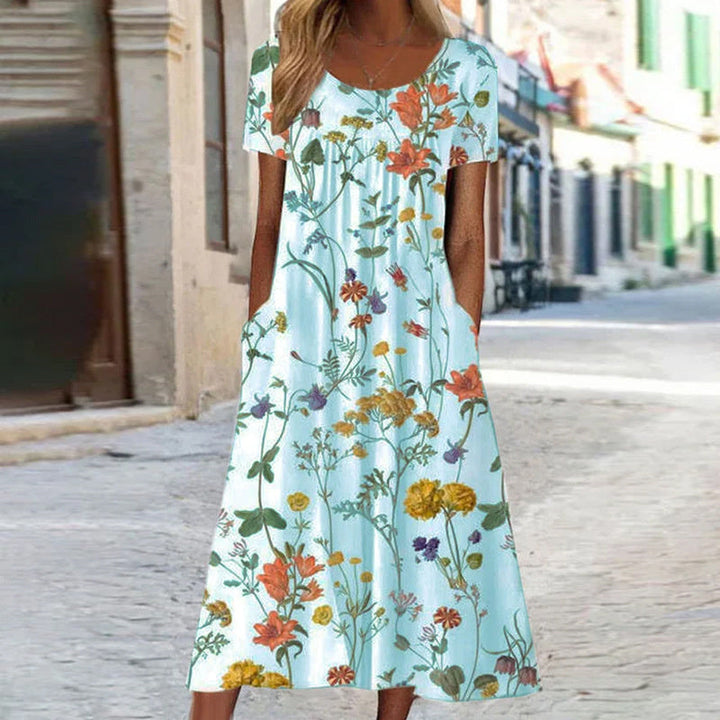 Versatile abito lungo floreale donna svasato, senza maniche. Ideale per l'estate, combina eleganza e freschezza.