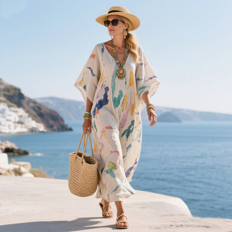 Moda mare donna, abito lungo estivo bohémien con stampe fluide e colori pastello.
