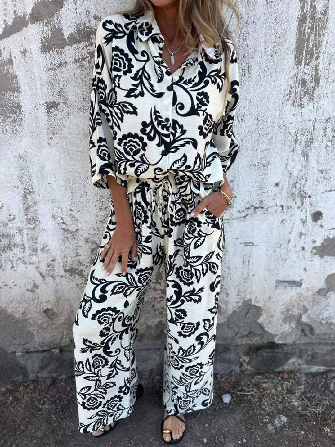 Elegante casual: completo donna due pezzi verde con stampa foglie, pantaloni larghi, perfetto per outfit da giorno.