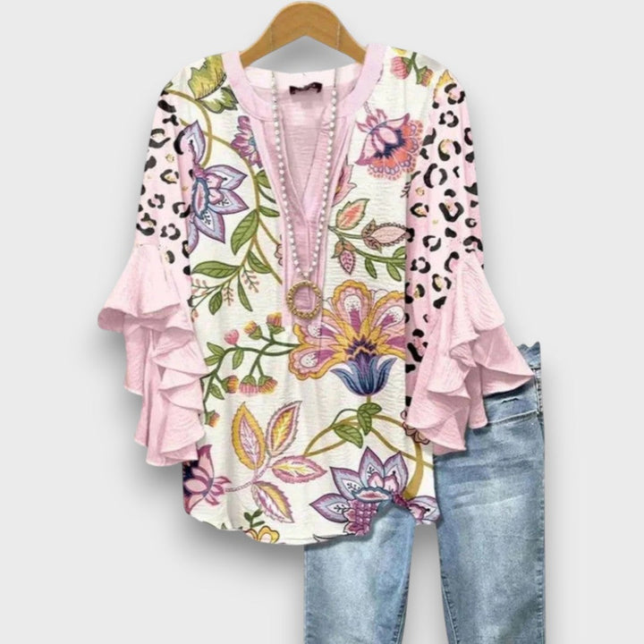 Camicetta donna elegante con lacci e volant. Scollo a V, motivo floreale. Perfetta per un look fresco estivo.