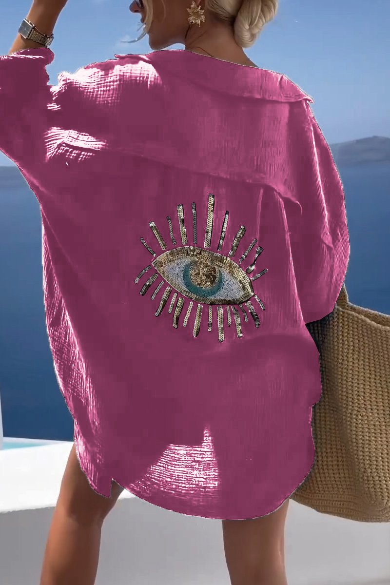 Camicia donna oversize alla moda con dettagli ricamati a occhio e paillettes. Ideale per un'estate glamour.